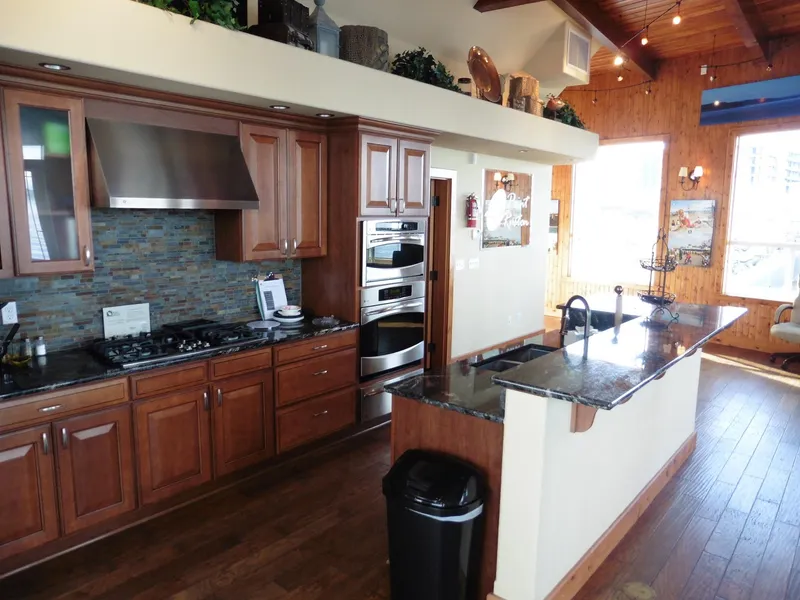 Slide: The Image of Modern kitchen on a 1936 custom ferry with wooden cabinets and granite countertops. - 35