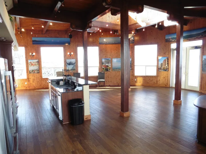 Slide: The Image of Spacious wooden interior of a 1936 custom ferry with large windows and modern kitchen. - 39