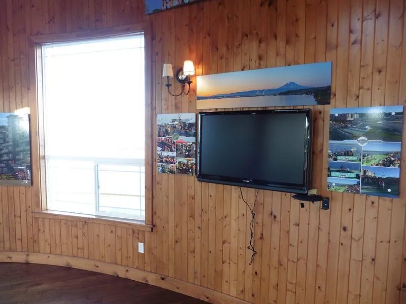 Slide: The Image of Wood-paneled room with wall-mounted TV, scenic photos, and large window. - 40