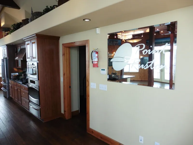 Slide: The Image of Modern kitchen with wooden cabinets, stainless steel appliances, and Point Ruston sign on the wall. - 42