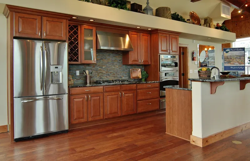 Slide: The Image of Modern kitchen with stainless steel appliances, wooden cabinets, and granite countertops. - 7