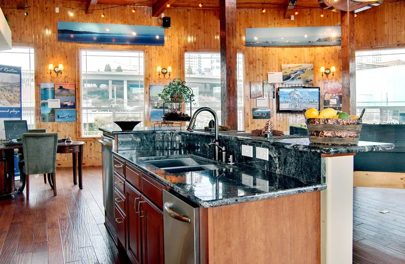 Slide: The Image of 1936 Custom Ferry interior with modern kitchen, granite countertops, and wooden walls. - 9