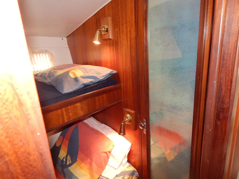 Slide: The Image of 1972 Hatteras 38 Convertible cabin with wooden interior and cozy bunk beds. - 14