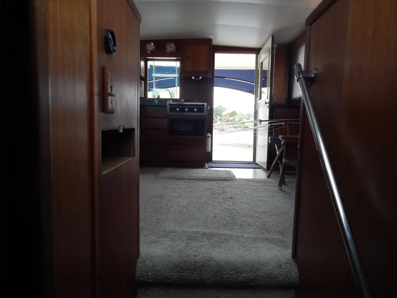 Slide: The Image of Interior view of 1972 Hatteras 38 Convertible yacht with wood paneling and carpeted flooring. - 15