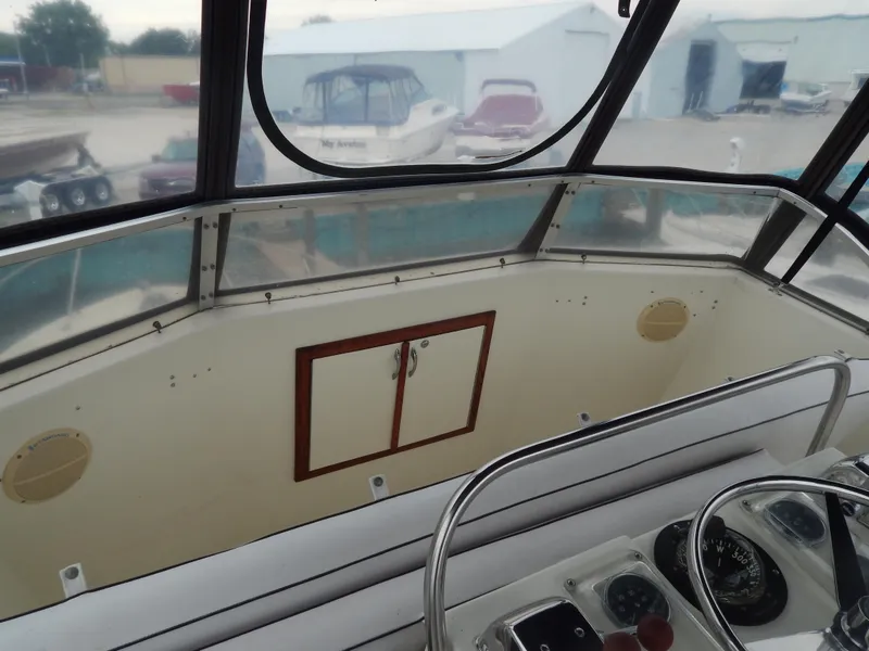 Slide: The Image of 1972 Hatteras 38 Convertible boat cockpit with steering controls and storage cabinet. - 3
