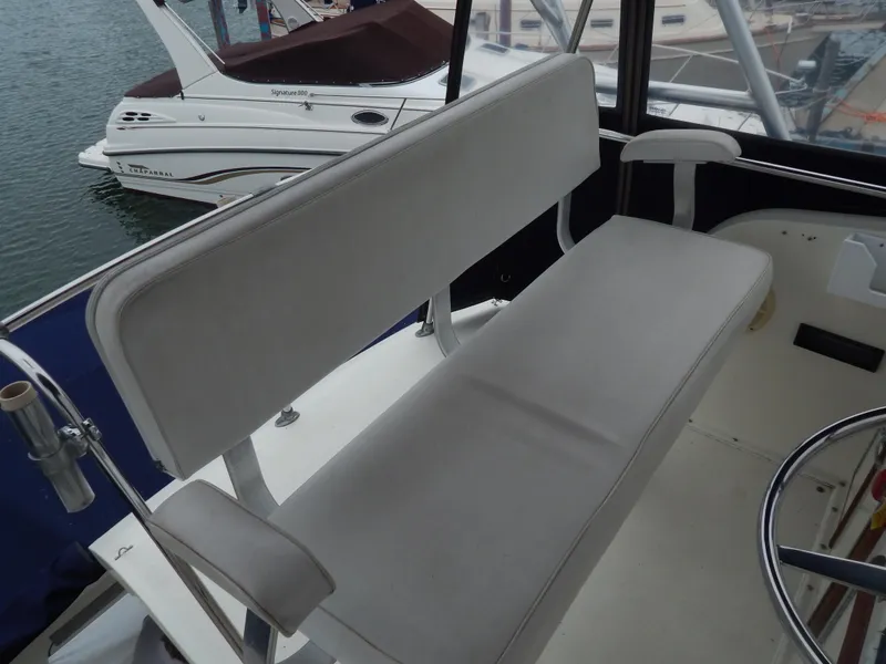 Slide: The Image of 1972 Hatteras 38 Convertible boat interior with cushioned seating and steering area. - 4