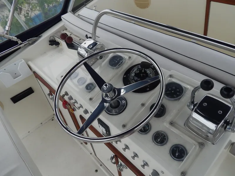 Slide: The Image of 1972 Hatteras 38 Convertible helm with steering wheel and control panel. - 5