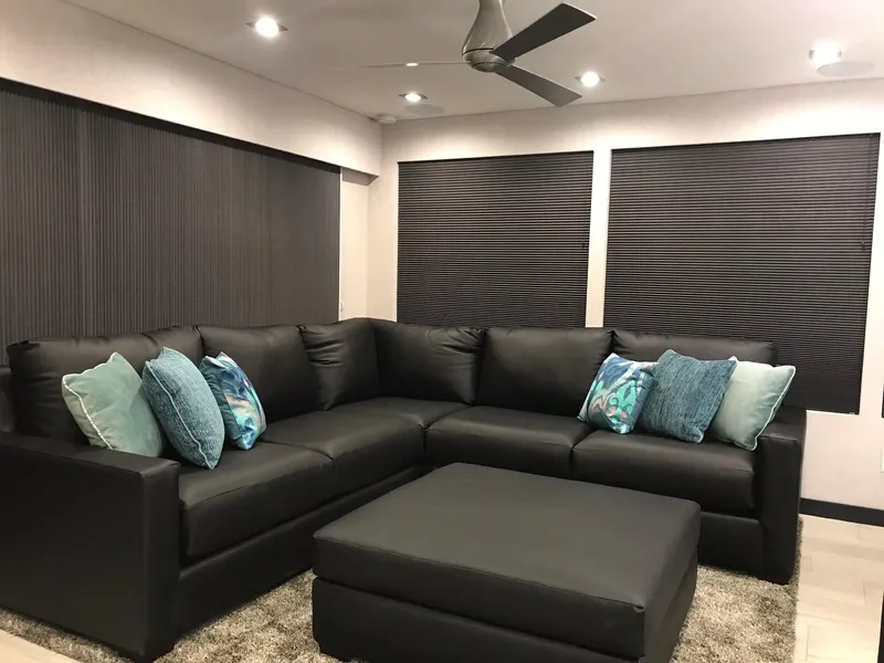 Slide: The Image of Modern living room with black sofa and blue pillows, Adonia Del Sol Trip 2018. - 11