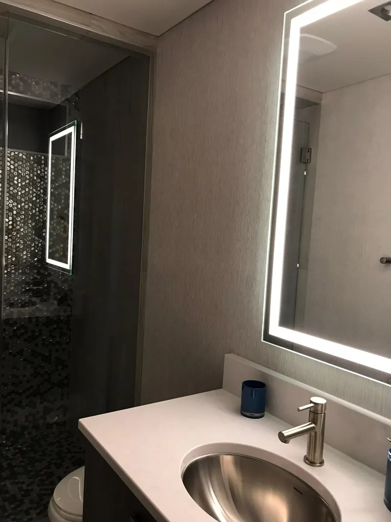 Slide: The Image of Modern bathroom with illuminated mirror and sink, Adonia Del Sol Trip 2018. - 18