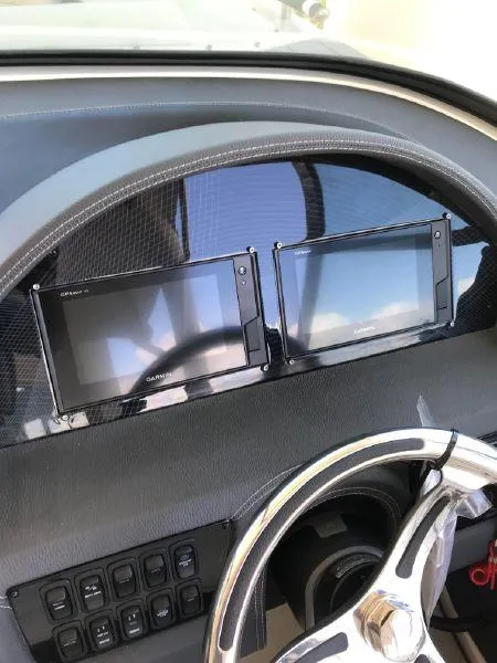 Slide: The Image of 2022 Regal 29 OBX dashboard with dual Garmin displays and steering wheel. - 10