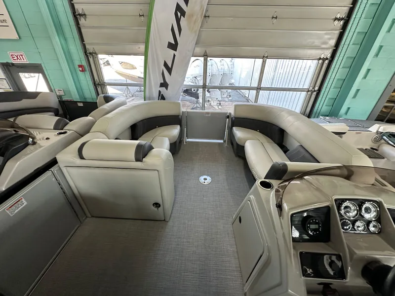 Slide: The Image of 2025 Sylvan Mirage 8522 CLZ DH pontoon boat interior with plush seating and modern dashboard. - 10