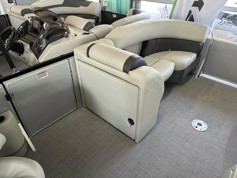 Slide: The Image of 2025 Sylvan Mirage 8522 CLZ DH boat interior with plush seating and modern dashboard. - 11