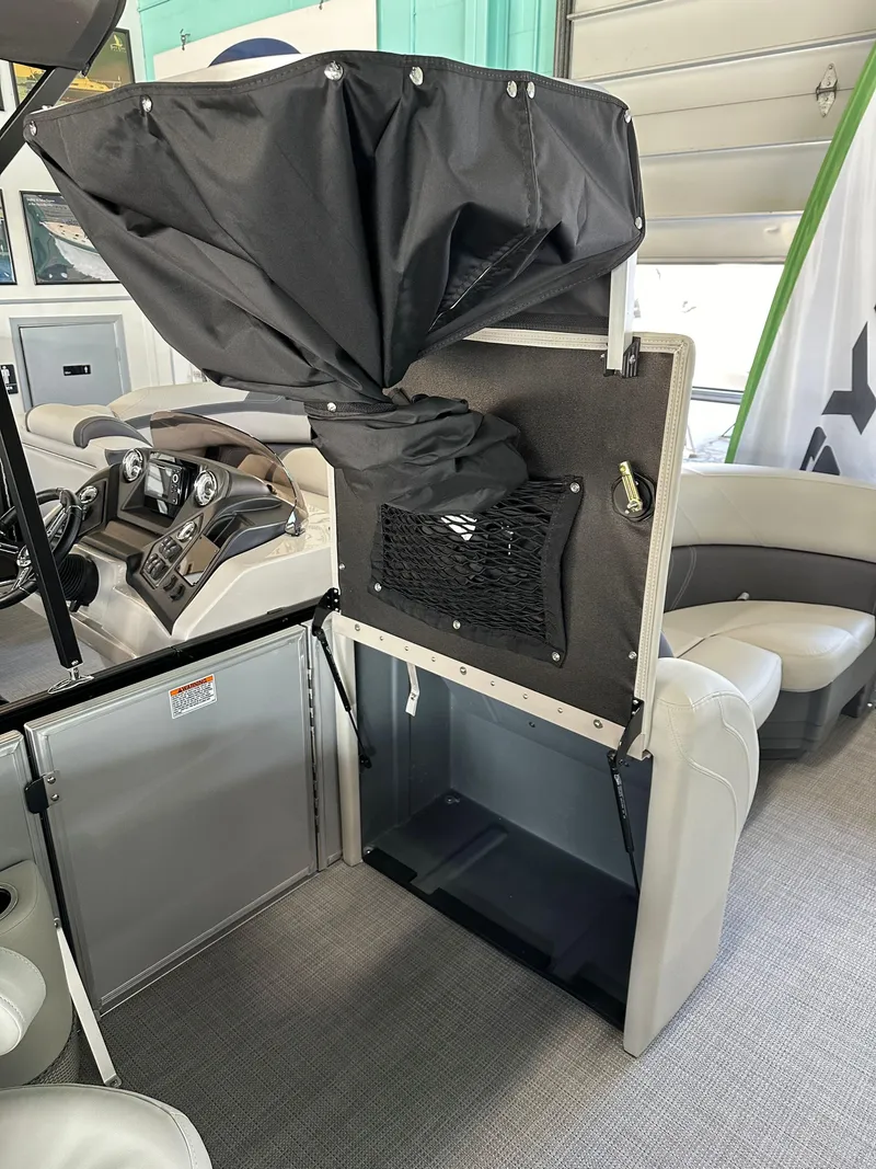 Slide: The Image of 2025 Sylvan Mirage 8522 CLZ DH boat interior with storage compartment open. - 12