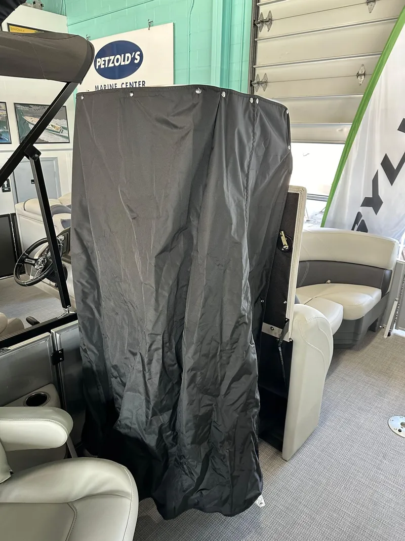 Slide: The Image of 2025 Sylvan Mirage 8522 CLZ DH interior with covered console at Petzold's Marine Center. - 13