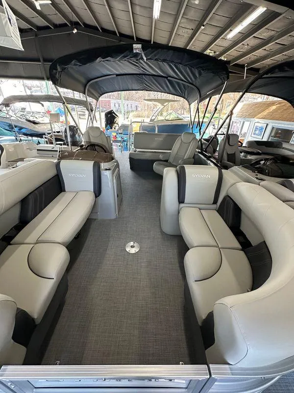 Slide: The Image of 2025 Sylvan Mirage 8522 CLZ DH pontoon boat interior with plush seating. - 14