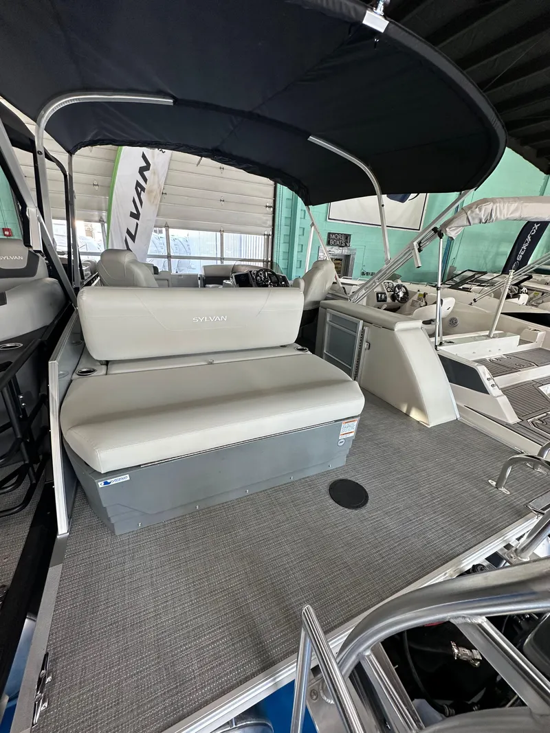 Slide: The Image of 2025 Sylvan Mirage 8522 CLZ DH pontoon boat interior with seating and canopy. - 2