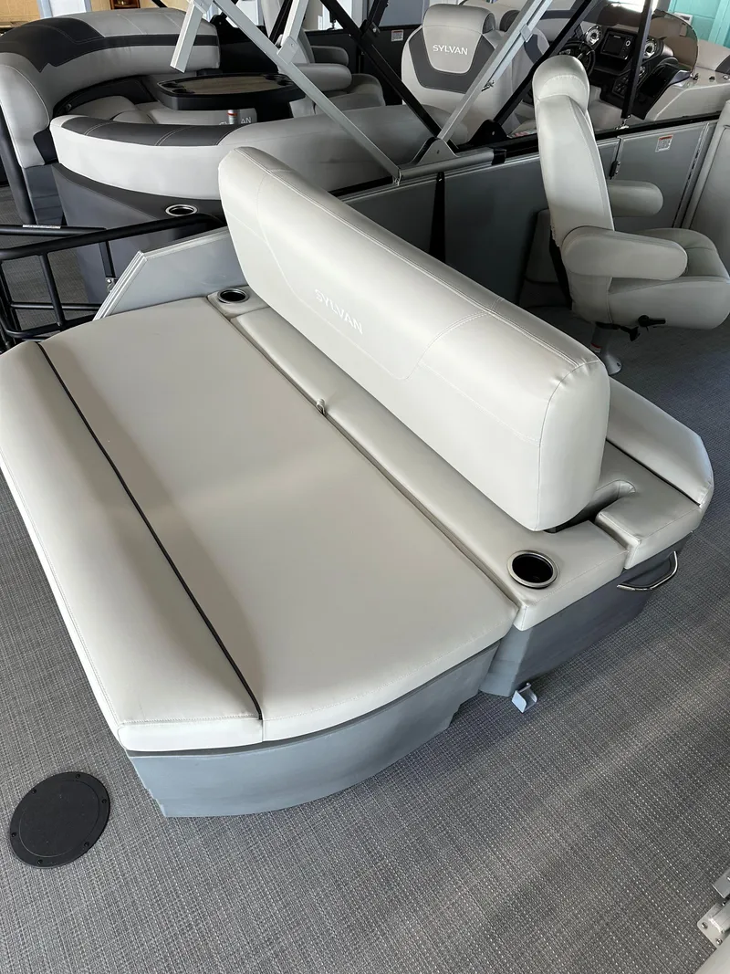 Slide: The Image of 2025 Sylvan Mirage 8522 CLZ DH boat interior with gray seating and cup holders. - 3