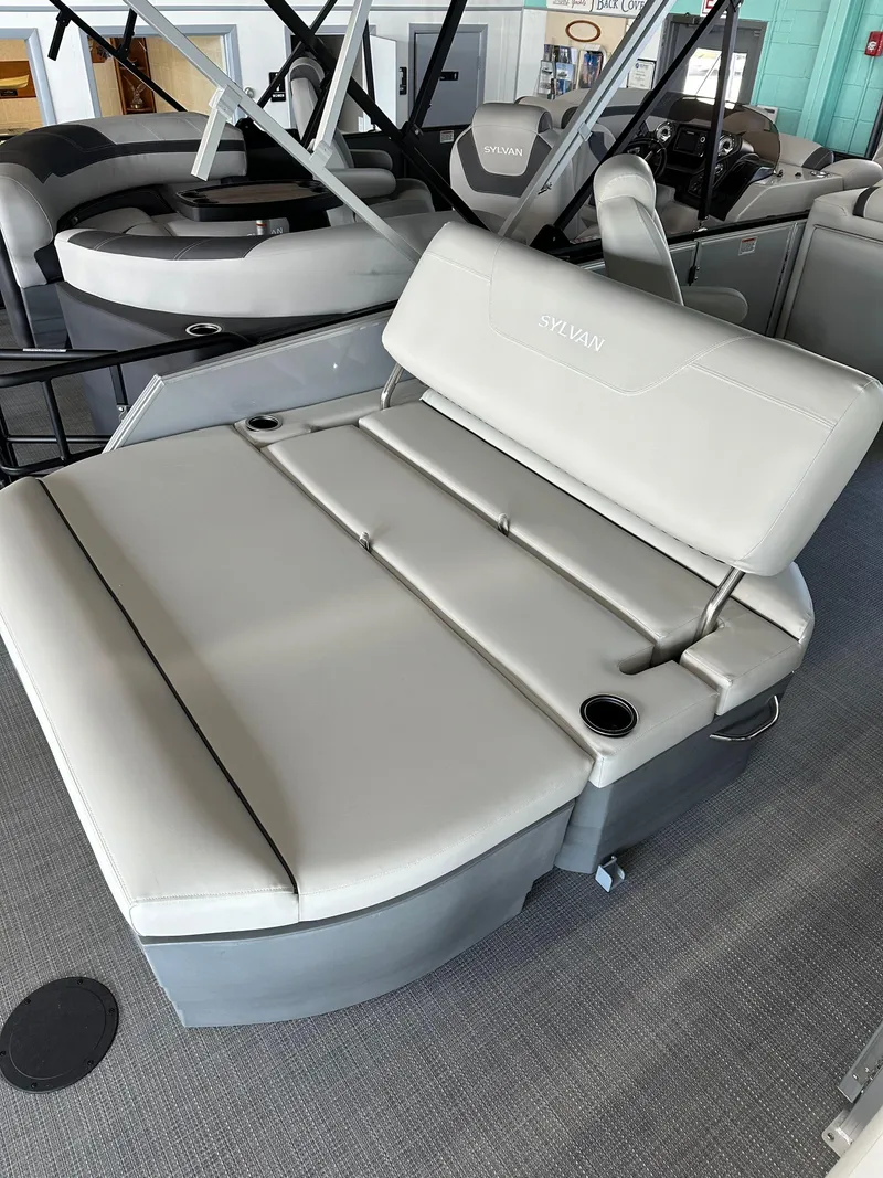 Slide: The Image of 2025 Sylvan Mirage 8522 CLZ DH boat interior with gray seating and cup holders. - 4