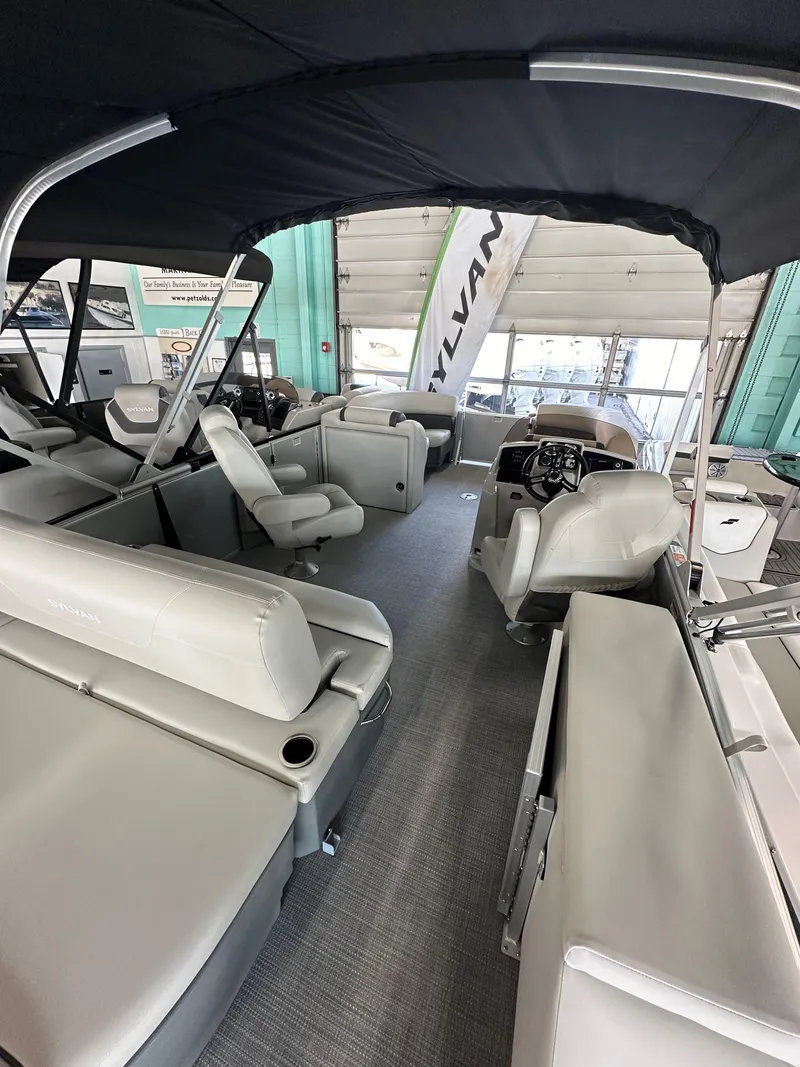 Slide: The Image of 2025 Sylvan Mirage 8522 CLZ DH pontoon boat interior with spacious seating and modern design. - 5