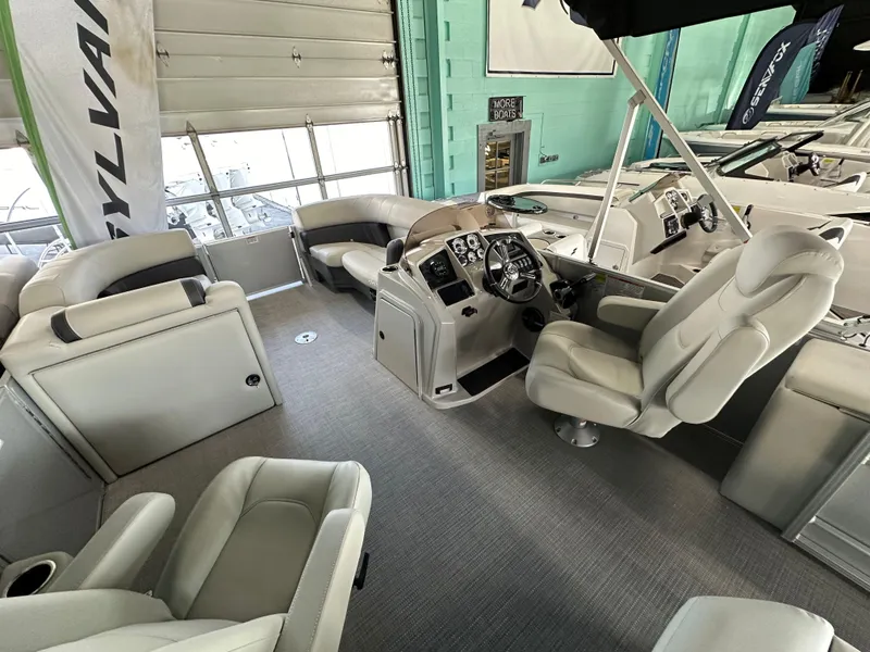 Slide: The Image of Interior of 2025 Sylvan Mirage 8522 CLZ DH pontoon boat, featuring luxurious seating and helm. - 7