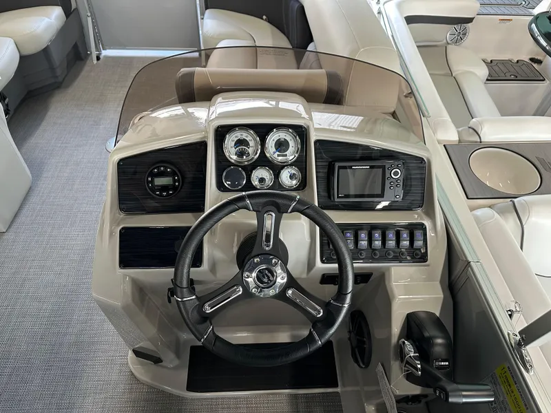 Slide: The Image of 2025 Sylvan Mirage 8522 CLZ DH boat dashboard with steering wheel and controls. - 9