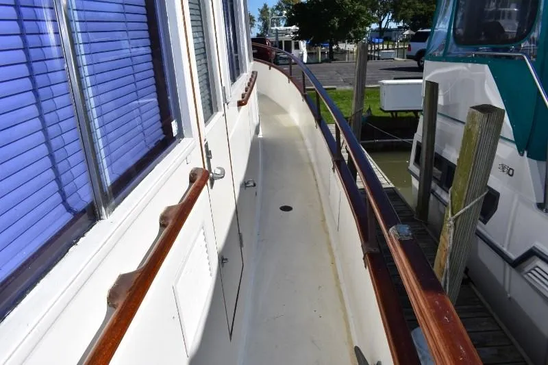 Slide: The Image of Side deck of 1985 Grand Banks 49 Motoryacht in harbor. - 13