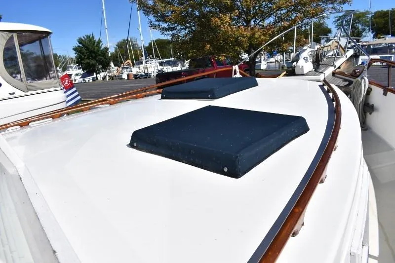 Slide: The Image of 1985 Grand Banks 49 Motoryacht deck with blue covers. - 15