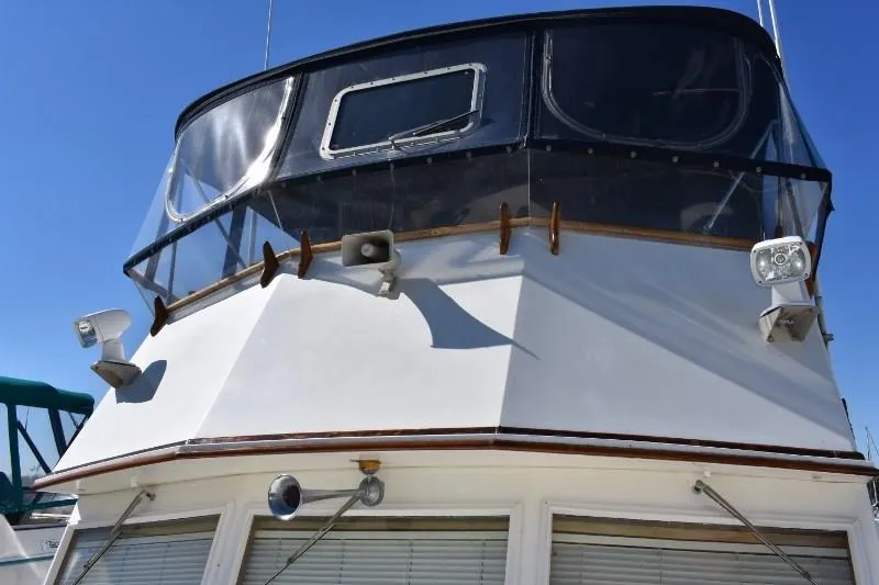Slide: The Image of 1985 Grand Banks 49 Motoryacht, front view with clear blue sky. - 20
