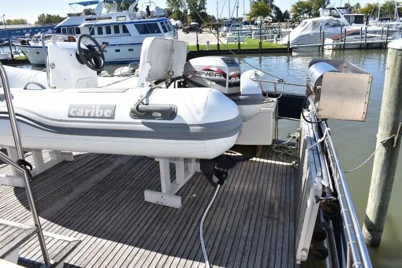 Slide: The Image of 1985 Grand Banks 49 Motoryacht with dinghy at dock. - 23