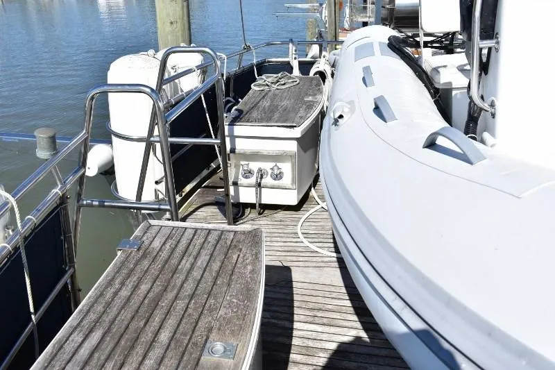 Slide: The Image of Deck of 1985 Grand Banks 49 Motoryacht with dinghy. - 25