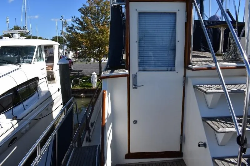 Slide: The Image of Entrance door of 1985 Grand Banks 49 Motoryacht with stairs and railing. - 32