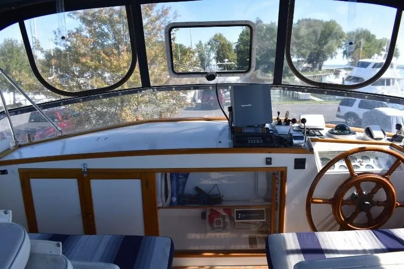 Slide: The Image of Interior view of 1985 Grand Banks 49 Motoryacht, helm with wooden steering wheel. - 37