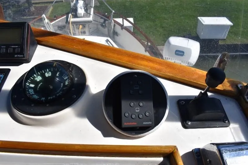 Slide: The Image of 1985 Grand Banks 49 Motoryacht helm with compass and controls. - 43