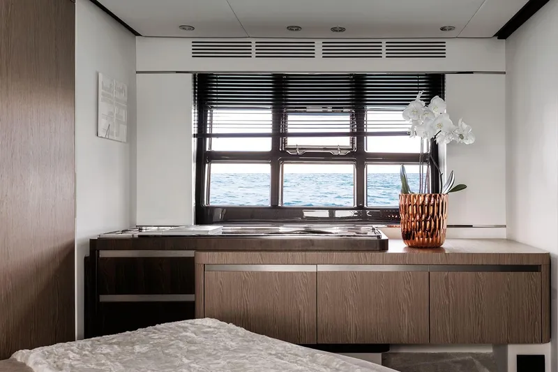 Slide: The Image of Interior of 2023 Azimut S6 yacht with modern wooden cabinetry and ocean view. - 16