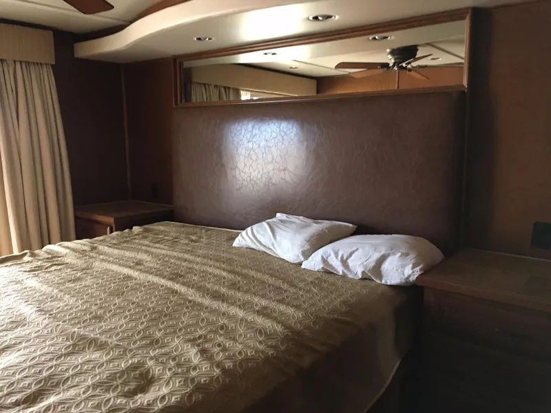 Slide: The Image of Interior of a Bravada RV, cozy bedroom with double bed, 2012 model. - 11