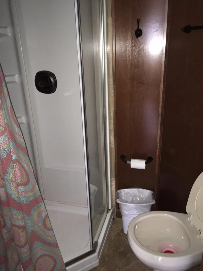 Slide: The Image of Compact bathroom in a 2012 Bravada RV model. - 14