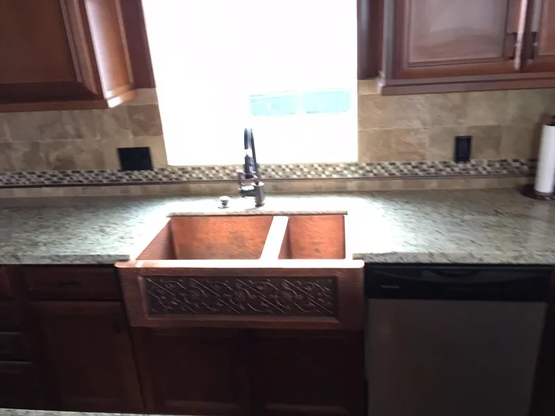 Slide: The Image of Kitchen countertop with copper sink and granite surface, Bravada 2012. - 5