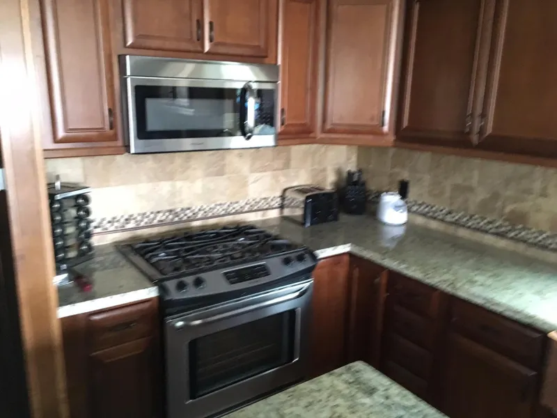 Slide: The Image of Modern kitchen with wooden cabinets and stainless steel appliances, 2012. - 6