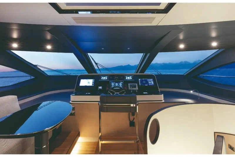 Slide: The Image of 2023 Azimut Grande 32 Metri yacht helm station with panoramic ocean view at sunset. - 31