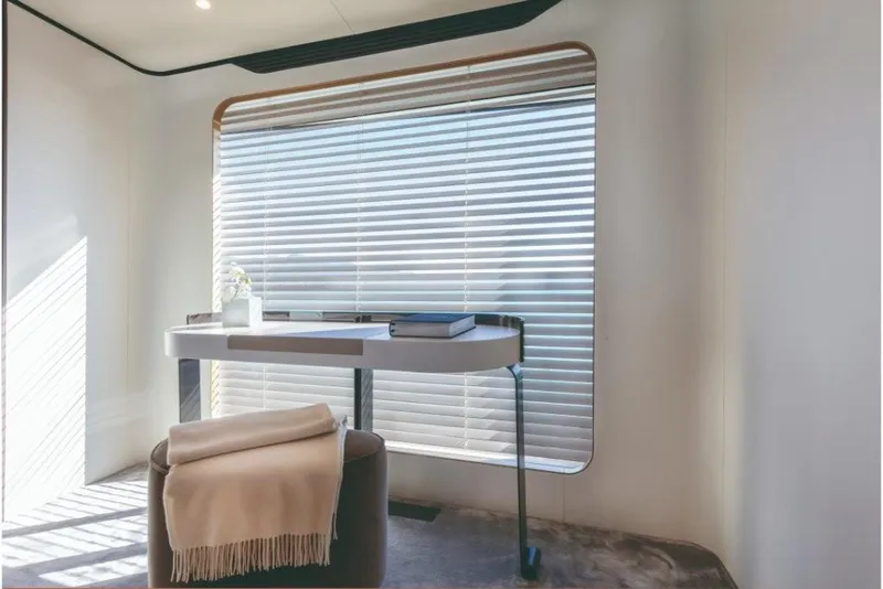 Slide: The Image of Modern interior of Azimut Grande 32 Metri yacht, 2023 model, featuring a sleek desk and window blinds. - 41