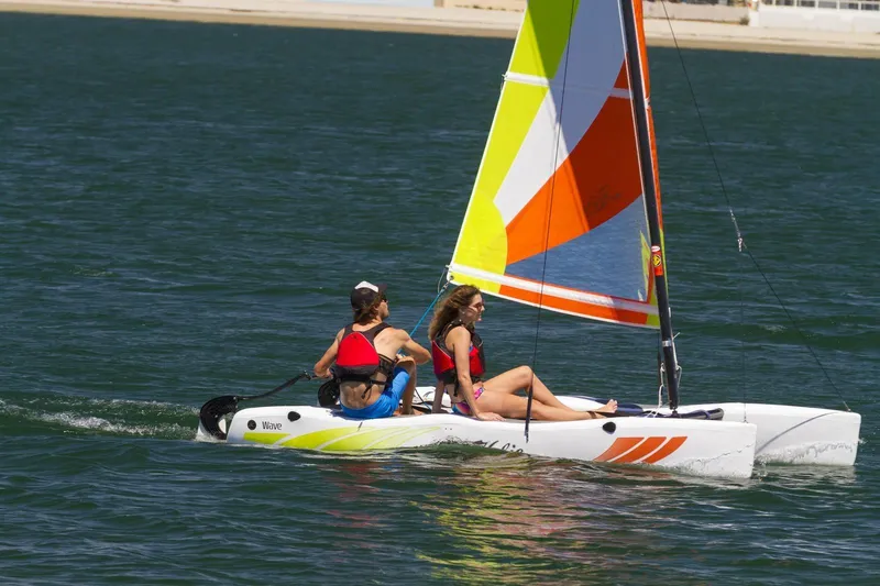 The Image of 2023 Hobie Cat Wave sailboat with two people sailing on a sunny day. - 0