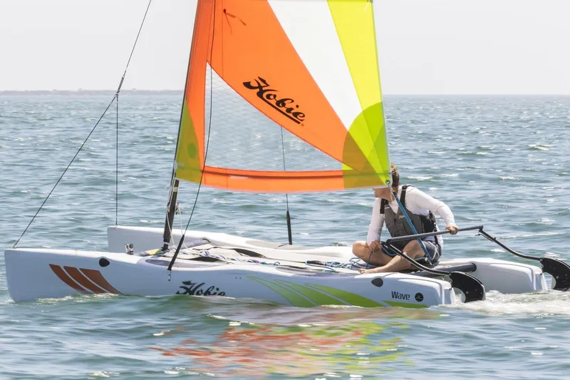 Slide: The Image of 2023 Hobie Cat Wave sailing on the ocean with colorful sail. - 3
