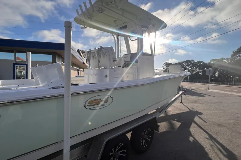 Slide: The Image of 2019 Sea Hunt BX 25 FS boat on trailer, sunlit, parked outdoors. - 10