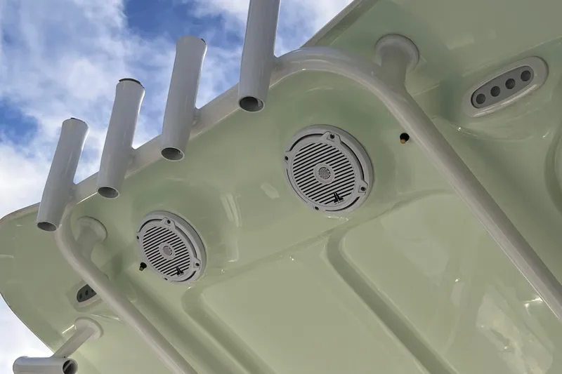 Slide: The Image of 2019 Sea Hunt BX 25 FS boat speakers and rod holders against a blue sky. - 14