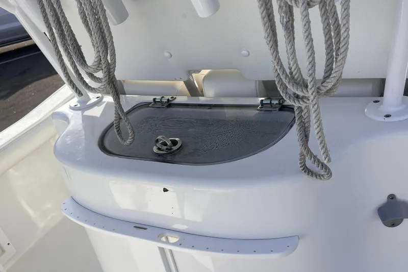 Slide: The Image of 2019 Sea Hunt BX 25 FS boat with storage compartment and coiled ropes. - 15