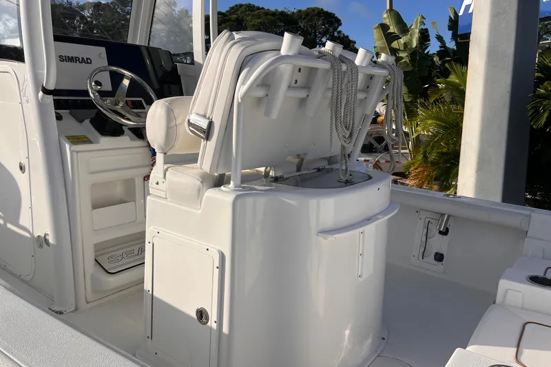 Slide: The Image of 2019 Sea Hunt BX 25 FS boat interior with steering wheel and seating. - 16