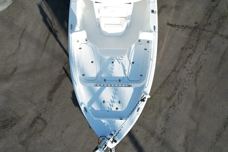 Slide: The Image of 2019 Sea Hunt BX 25 FS boat, aerial view, white deck, parked on concrete surface. - 20