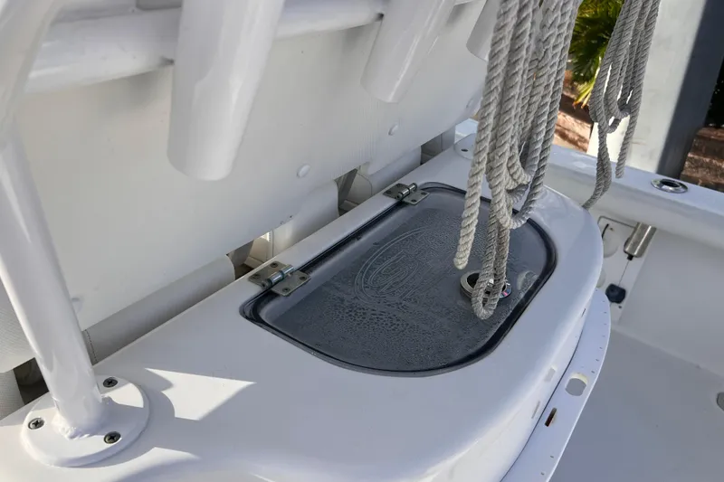 Slide: The Image of 2019 Sea Hunt BX 25 FS boat with open storage compartment and ropes. - 21