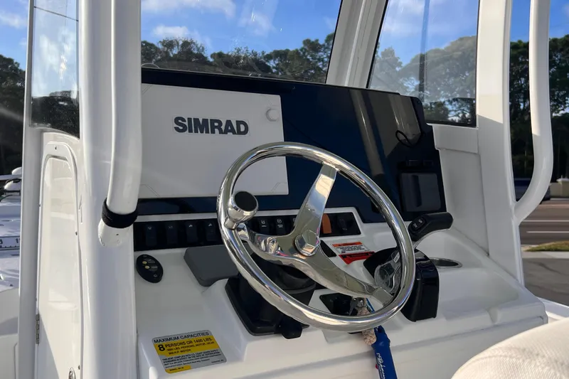 Slide: The Image of 2019 Sea Hunt BX 25 FS boat console with Simrad display and steering wheel. - 7