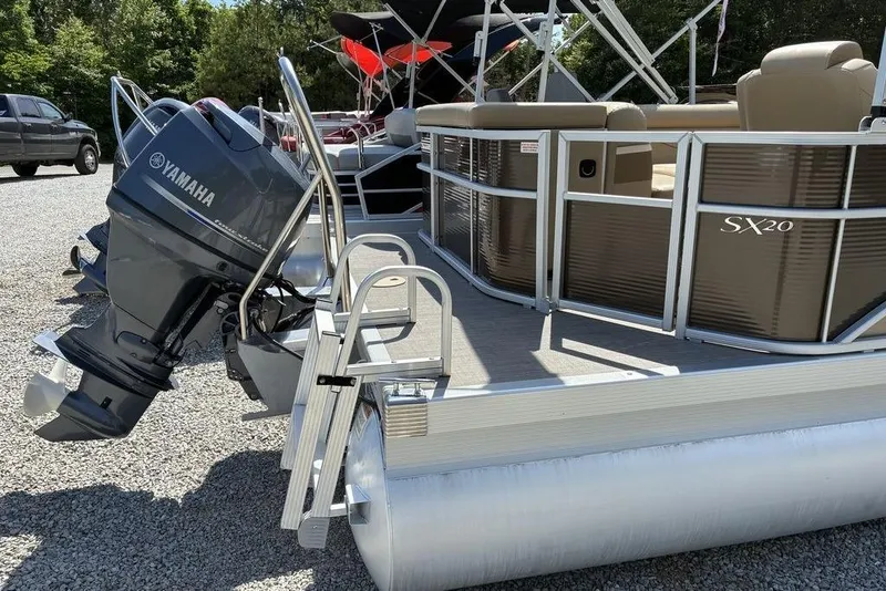 Slide: The Image of 2017 Bennington 20SLMX pontoon boat with Yamaha outboard motor, parked on gravel. - 5